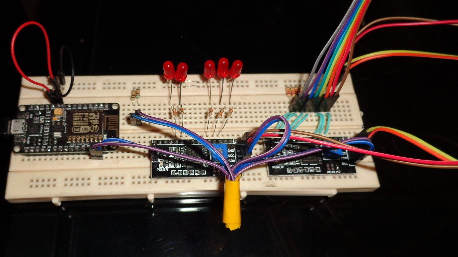 Up close: the ESP8266 board, five LEDs and two I²C expander boards, with the keypad's ribbon cable coming in from the right.